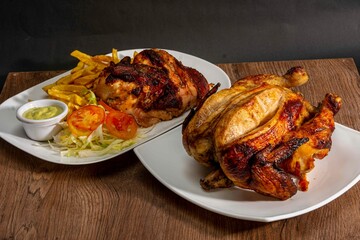Deliciously charred and smoky Pollo a la Brasa (grilled chicken) served whole and in pieces, accompanied by crispy fries, fresh salad, and a flavorful dipping sauce. A classic Latin American dish, coo