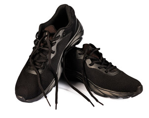 Beautiful black sneakers isolated on a white background. Sports black sneakers.