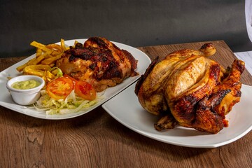 Deliciously charred and smoky Pollo a la Brasa (grilled chicken) served whole and in pieces, accompanied by crispy fries, fresh salad, and a flavorful dipping sauce. A classic Latin American dish, coo