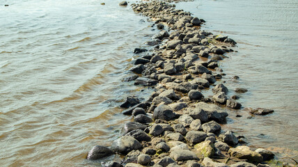 Rocky bank of a large river on a sunny day