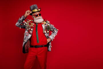 Photo of attractive funny santa calus wear jacket celebrating xmas looking emtpy space isolated red color background