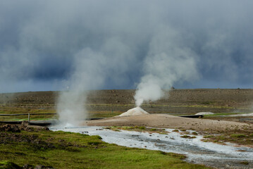 Geothermal Hot Springs in Lush Green Icelandic Landscape with Rising Steam