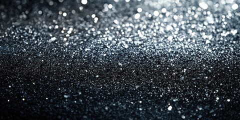 Obraz premium Sparkling black glitter on a dark background.