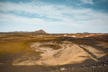 Desolate Volcanic Crater Landscape Under Clear Sky with Rugged Terrain