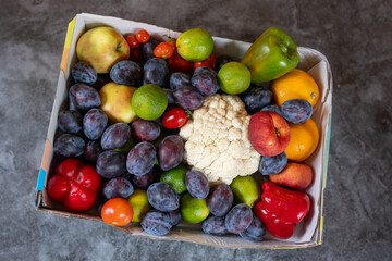 Schachtel voller Zwetschgen und weiteres Obst und Gemüse