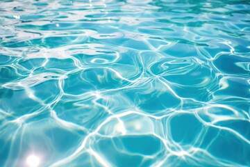 Close-up of crystal-clear blue water with gentle ripples and sunlight reflections, creating a calming and refreshing aquatic scene. Background element for design.