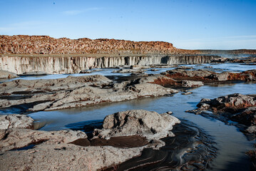 Rugged Terrain and Water Stream at Sunset
