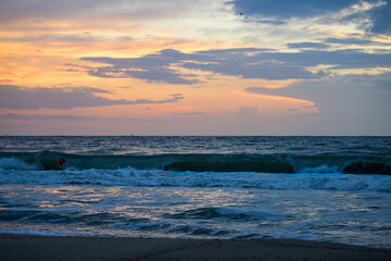 The sun with colored clouds from the sunrise, in the morning. Beautiful scenery by the sea. 