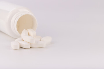 Medicine Bottles on White Background with Open Bottle Showing Pills