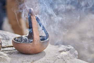 coca leaf offering, payment to Pachamama in northern Argentina. Ritual traditional with incense