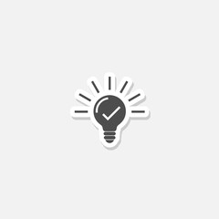 Light bulb with tick icon sticker isolated on gray background