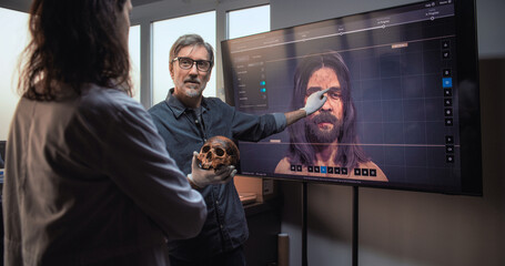 Male and female scientists or archaeologists talk, examine fossil skull and conduct scientific...