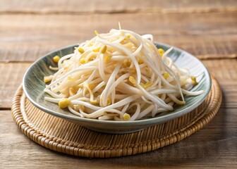 Freshly steamed bean sprouts, glistening with moisture, arranged artfully on a small, creamy ceramic plate, captured with a shallow depth of field to emphasize the tender, crunchy texture.