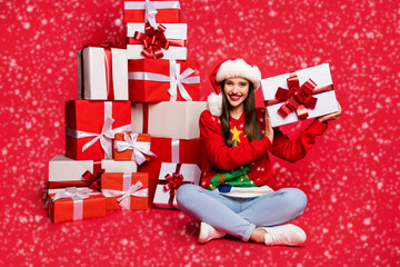 Photo of charming sweet young woman dressed ugly pullover arm cheek getting many presents isolated red color background