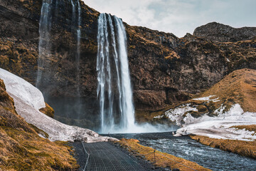 Seljalandsfoss waterfall flowing in autumn wilderness at Iceland