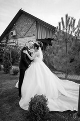 Romantic Black and White Wedding Portrait of a Bride and Groom Embracing Outdoors