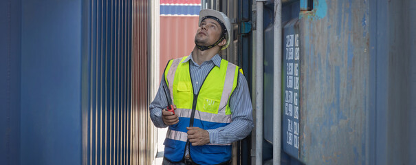 Foreman or worker work at Container cargo site check up goods in container. Foreman or worker checking on shipping containers. Logistics and shipping.