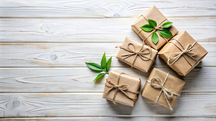 Beautifully wrapped gift boxes with natural green leaves on white wooden background create warm and inviting atmosphere. Perfect for celebrations and special occasions