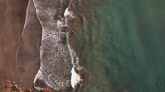 Aerial view of serene sunrise over the beautiful ocean and tranquil beach, Arico, Spain.