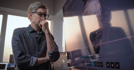 Male and female scientists or archaeologists discuss and study cultural artifact, conduct...