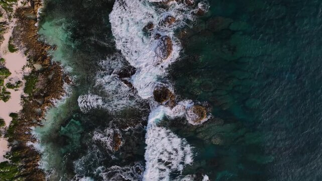 Aerial view of tropical island reef with beautiful turquoise ocean and foamy waves, Tongatapu, Tonga.