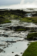 Geothermal Hot Springs in Lush Green Icelandic Landscape with Rising Steam