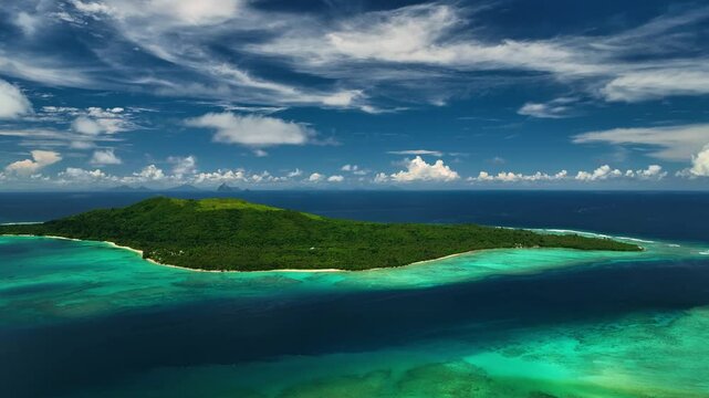 Aerial view of a tropical island with clear water, lush greenery, and serene waves, Shefa Province, Vanuatu.