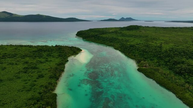 Aerial view of a beautiful tropical island lagoon surrounded by lush greenery and a pristine reef, Shefa Province, Vanuatu.