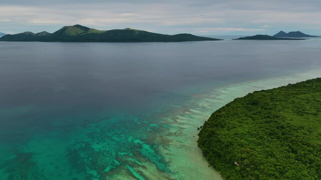 Aerial view of a beautiful tropical island with a pristine lagoon and coral reef, Shefa Province, Vanuatu.