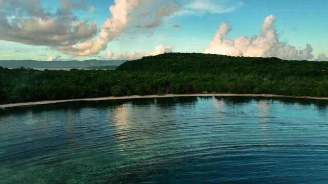 Aerial view of a beautiful tropical island at sunset with serene ocean reflections, Shefa Province, Vanuatu.