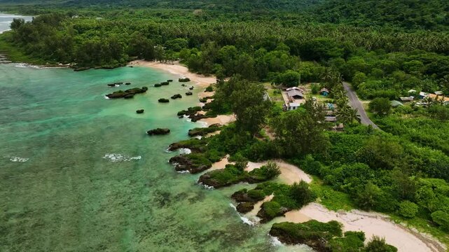 Aerial view of a tropical island with lush palms and clear turquoise water, Shefa Province, Vanuatu.