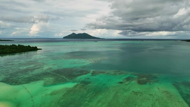 Aerial view of a tropical island with a serene lagoon and unspoiled reef, Shefa Province, Vanuatu.