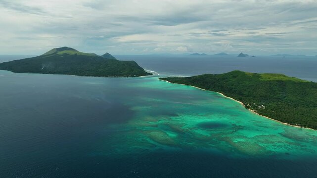 Aerial view of a beautiful tropical island with a serene lagoon and lush palms, Shefa Province, Vanuatu.