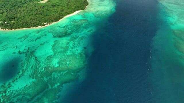 Aerial view of a breathtaking tropical island with a pristine lagoon, vibrant reef, and clear turquoise water, Shefa Province, Vanuatu.