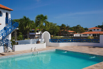  beach house - blue sky, palm trees around you and view of the pool
