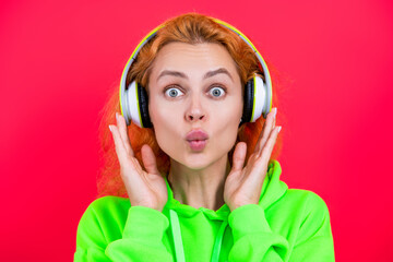 Millennial woman listen to music in headphones. Music concept. Millennial lifestyle. Woman listening audio in music headphones. Girl isolated on pink. Listen audio book. Good sound