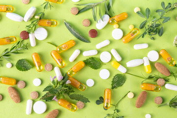Homeopathic medicine pills, various colorful medicine pills and capsules, dietary supplements with herbs and plants.. Natural and alternative medicine, Eco organic medicine concept