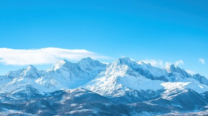 Majestic snow-capped mountains under a clear blue sky.