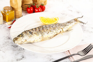 Grilled sea bass fish served lemon