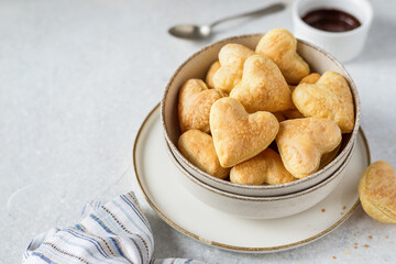 Puff pastry heart shaped dessert with chocolate dip for breakfast