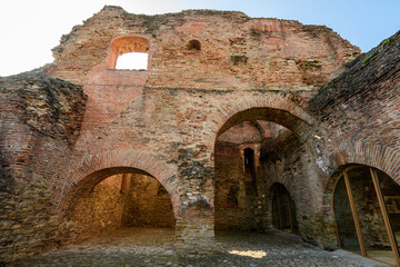 Fototapeta premium Old buildings and ruins at Targoviste Royal Court (Curtea Domneasca) in Chindia Park (Parcul Chindia) in the historical part of the city in a sunny spring day, in Romania