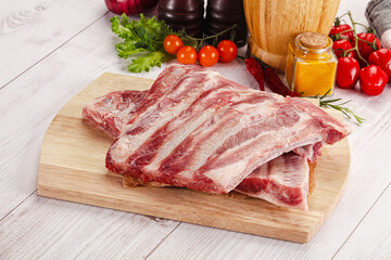 Raw pork ribs over board