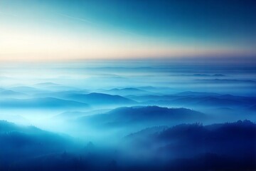 Fototapeta premium Misty mountain landscape with soft blue hues at dawn