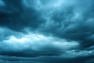 Obraz premium Dramatic dark clouds fill the sky, creating a moody atmosphere perfect for conveying emotion and depth in visual storytelling.