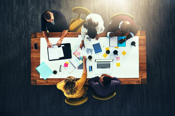 Above, paperwork or designers in meeting for color choice, teamwork and brainstorming in startup. Creative, group and strategy with laptop, people or graphs with documents, budget report or feedback