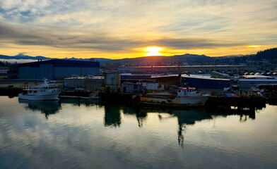 sunrise or sunset over the harbor, reflections. room for copy.