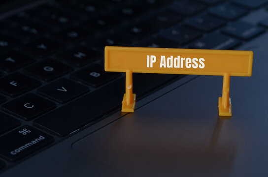 The sign reading IP Address on a laptop keyboard highlights the fundamental role of this unique identifier in online communication and connectivity