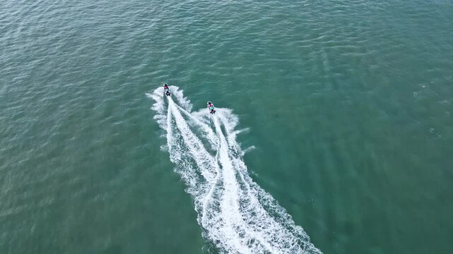 Aerial view of beautiful jetskis racing on the ocean waves, Pantai Cenang, Kuah, Malaysia.
