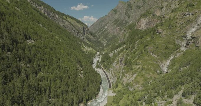 Aerial view of majestic alps with lush forests and a serene valley, Cogne, Italy.