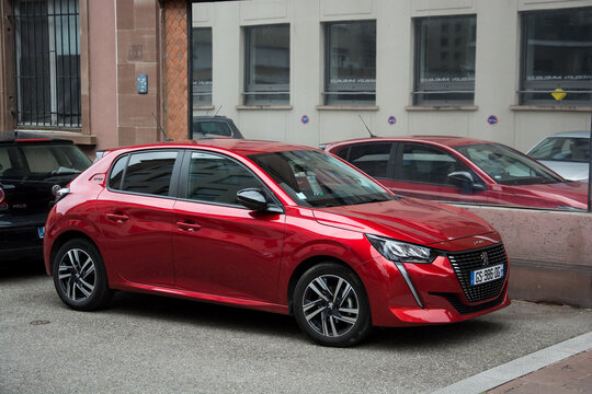 Mullhouse - France - 9 september 2024 - profile view of red peugeot 208 parked in the street